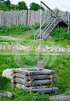 Old draw well with wooden bucket