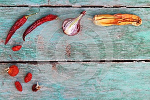 Old dried up, spoiled vegetables, onion, tomato, chili, zucchini on a wooden base