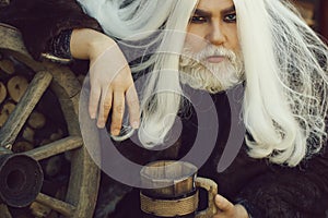 Old druid with wooden mug