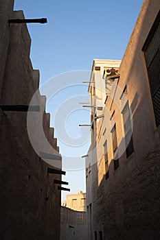 Old Dubai buildings and traditional Arabian street. Historical Al Fahidi neighbourhood, Al Bastakiya. Heritage district in United