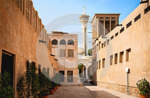 Old Dubai view with mosque, buildings and traditional Arabian street. Historical Al Fahidi neighbourhood, Al Bastakiya.