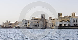 Old Dubai wind towers along the Dubai creek, as seen from an Abra water taxi