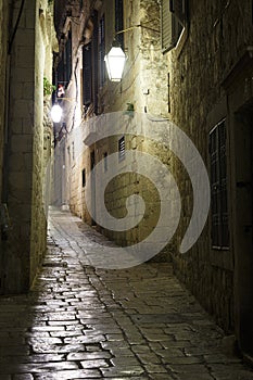Old Dubrovnik city at night. Medieval stone street illuminated by lanterns. Croatia. Europe