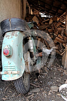 Old durty motor wirh split wood as background