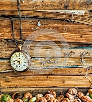 Old dusty books with broken pocket watch