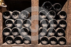 Old dusty bottles of red rioja wine in cellars, wine making in La Rioja region, Spain