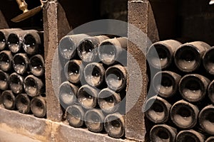 Old dusty bottles of red rioja wine in cellars, wine making in La Rioja region, Spain