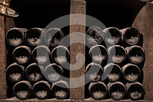 Old dusty bottles of red rioja wine in cellars, wine making in La Rioja region, Spain