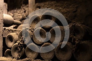 Old dusty bottles of red rioja wine in cellars, wine making in La Rioja region, Spain