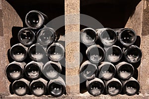 Old dusty bottles of red rioja wine in cellars, wine making in La Rioja region, Spain