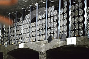 Old dusty bottles of wine are stored in the wine cellar