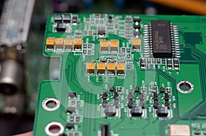 old dusty circuit board with electronic components close-up