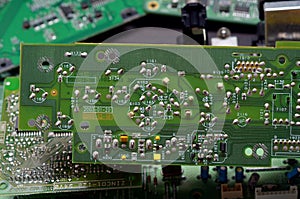 old dusty circuit board with electronic components close-up