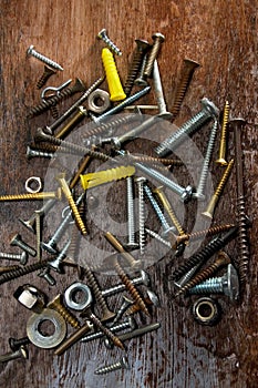 Old Dusty Rusted Nuts, Bolts and Screws on Rustic Wood