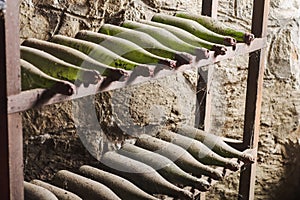 Old dusty wine bottles in the dark cellar
