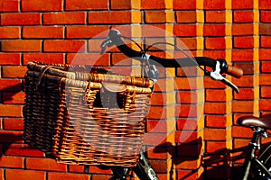 Old dutch bike wooden bicycle basket wall red orange wisker big vintage sun light brick