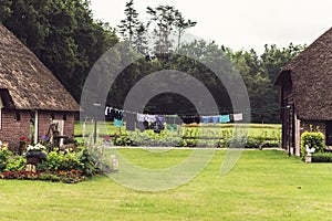 Old Dutch Farm in Summer with Laundry Drying Outdoors.