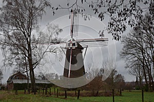 Old Dutch mill in winter landscape