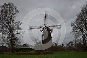 Old Dutch mill in winter landscape