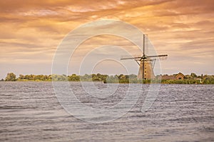 Old Dutch traditional windmill located at Rottemeren during suns