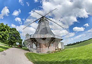 Old dutch windmill with blue cloudy sky