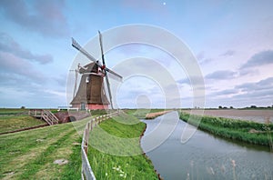 Old Dutch windmill by canal