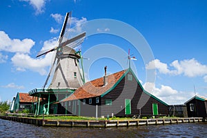 Old dutch windmill over river waters