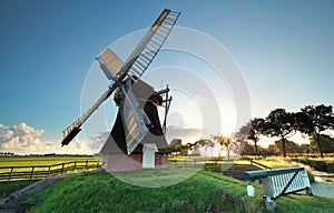 Old Dutch windmill at sunrise