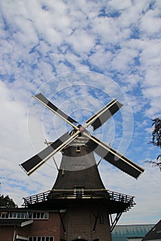 Old dutch windmill in villagye named Oldebroek with name De Hoop, still working as peel and as grind mill.