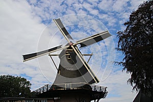 Old dutch windmill in villagye named Oldebroek with name De Hoop, still working as peel and as grind mill.