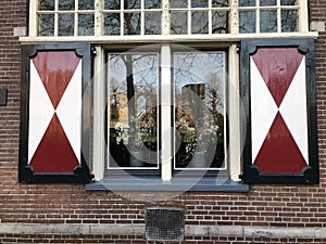 Old dutch window with shutters in laiden