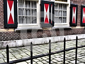 Old Dutch windows with red and white shutters in Utrecht, Netherlands.