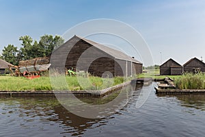 Old Dutch wooden barns near canal