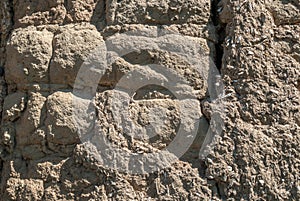 Old earthen bricks wall texture on daylight outside