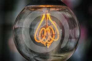 Old edison light bulb glowing in the dark