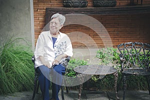 old elderly elder senior woman resting relaxing in garden