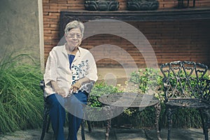 old elderly elder senior woman resting relaxing in garden