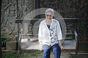 old elderly elder senior woman resting relaxing in garden