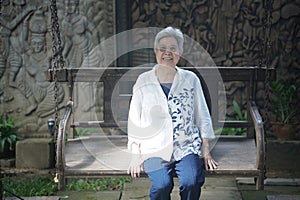 old elderly elder senior woman resting relaxing in garden