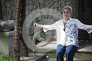 old elderly elder senior woman resting relaxing in garden