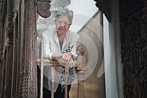 old elderly elder senior woman resting relaxing on terrace balcony