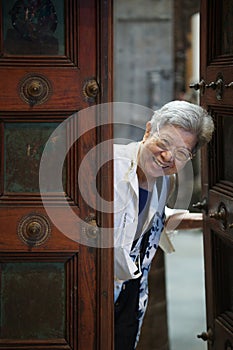 old elderly elder senior woman smiling at door