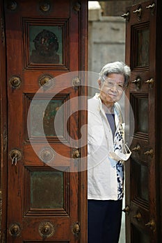 old elderly elder senior woman smiling at door