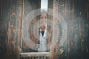 old elderly elder senior woman smiling at window