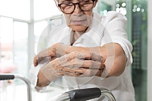 Old elderly scratching arm elbow itchy skin,skin irritation,atopic dermatitis or disorders of nerves and the nervous system,