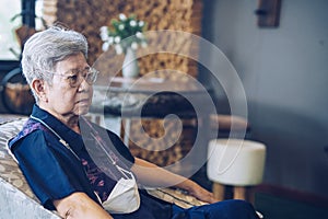 Old elderly senior elder woman relaxing in living room. retirement lifestyle