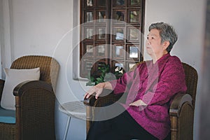 Old elderly senior elder woman resting relaxing on chair in living room