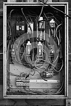 Old electric breaker box in black and white
