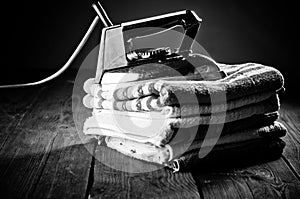 Old electric iron on the wooden background