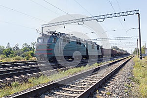Old electric locomotive carrying industrial loads